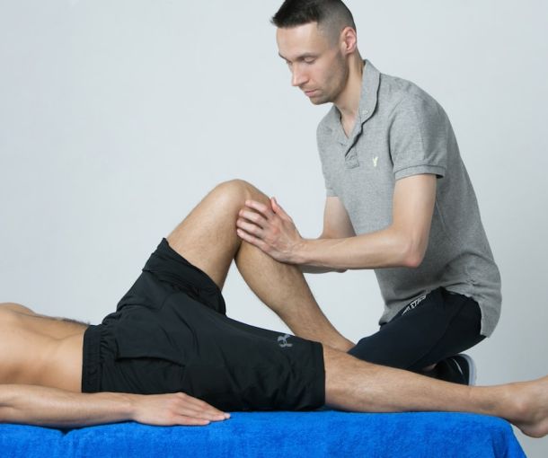 Patient undergoing physiotherapy knee rehabilitation exercises